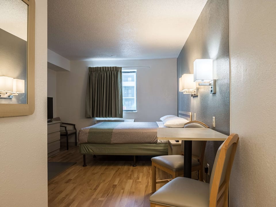 Desk, bed sheets, alarm clocks