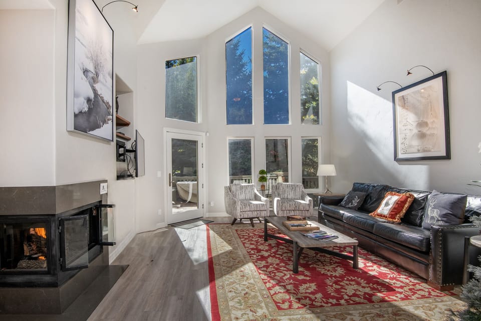 Living Room - Stunning Views and Natural Light with a Cozy Fireplace