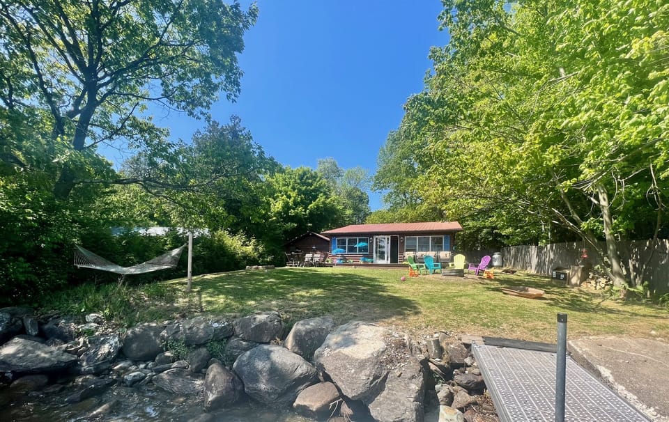 Large back lawn. Hammock, fire pit, and outside patio set