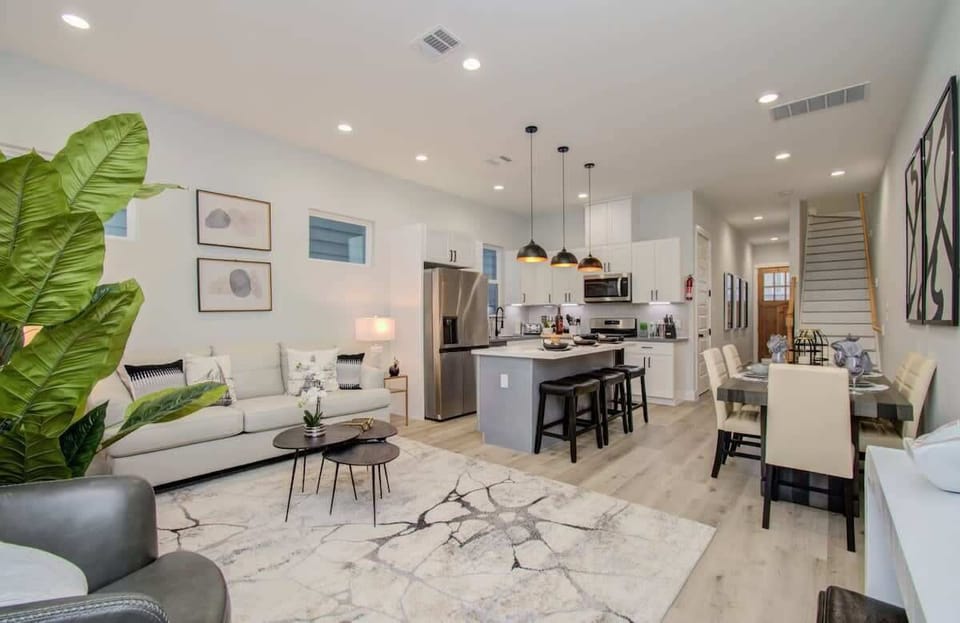 This open-concept living space offers the perfect blend of timeless elegance, contemporary flair, and cozy comfort for daily living.