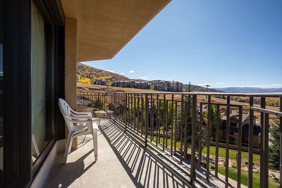 Step onto your private balcony and breathe in the crisp mountain air while taking in sweeping views of rolling hills and distant peaks.