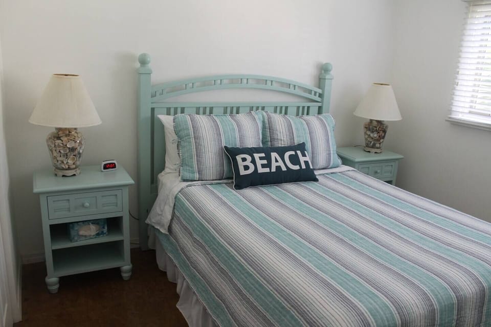 Guest bedroom has one queen bed and large closet.