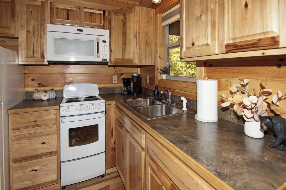 Prepare your favorite meals in the fully equipped kitchen with modern appliances and rustic charm.