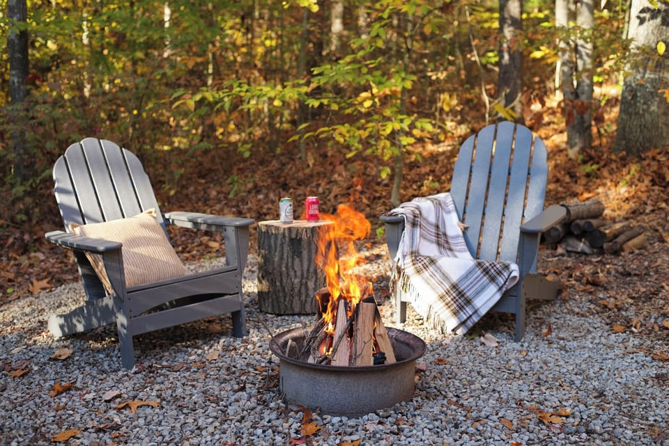 Unwind by the fire under a canopy of trees. The cozy outdoor fire pit is perfect for crisp evenings and quiet conversations.