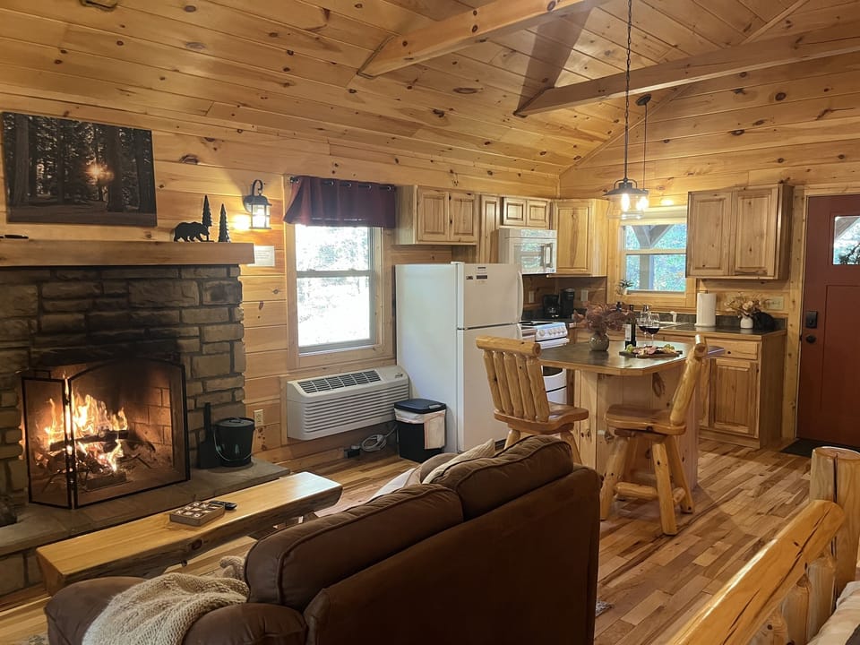 Cozy stone fireplace and a fully equipped kitchen.
