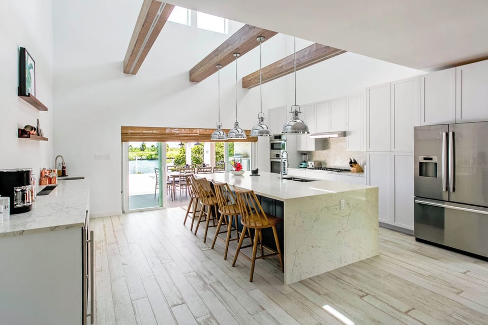 The gourmet kitchen comes equipped with a suite of modern appliances and kitchen island seating. 