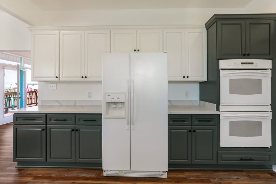 Full sized side-by-side refrigerator with water and ice in the door.