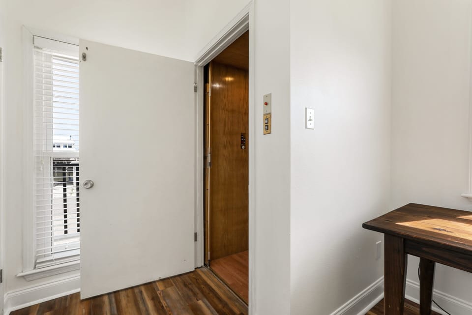 The elevator is located past the kitchen and laundry.