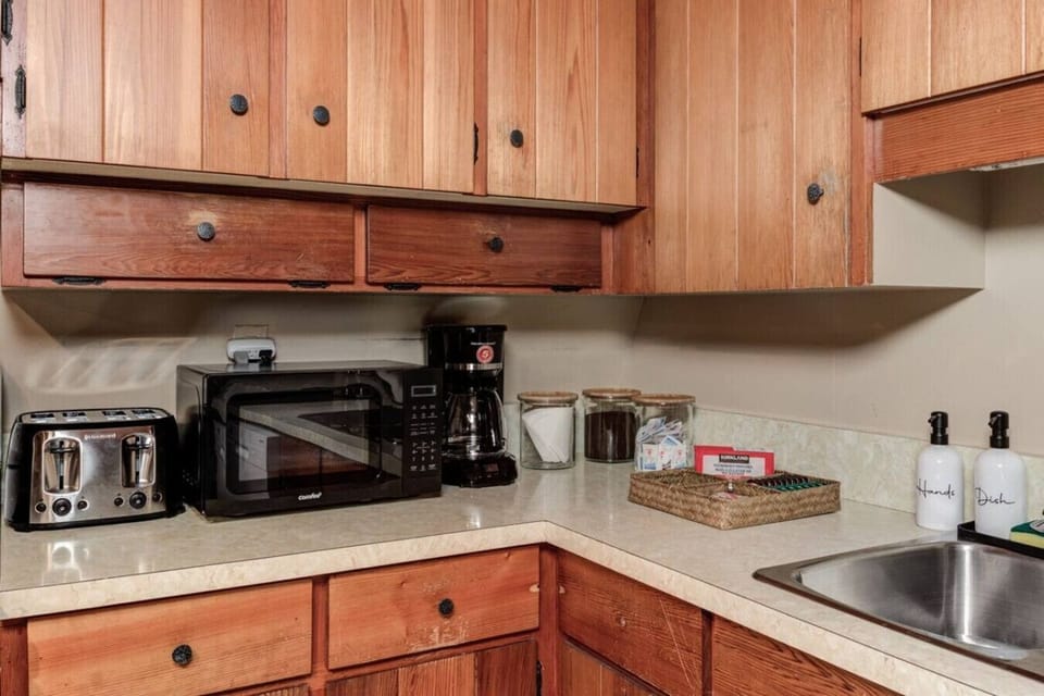 Start your mornings with ease in this thoughtfully stocked kitchen corner featuring a coffee maker, toaster, microwave, and all the essentials for quick snacks or hearty breakfasts. Whether you are brewing your favorite roast, toasting fresh bread, or hea