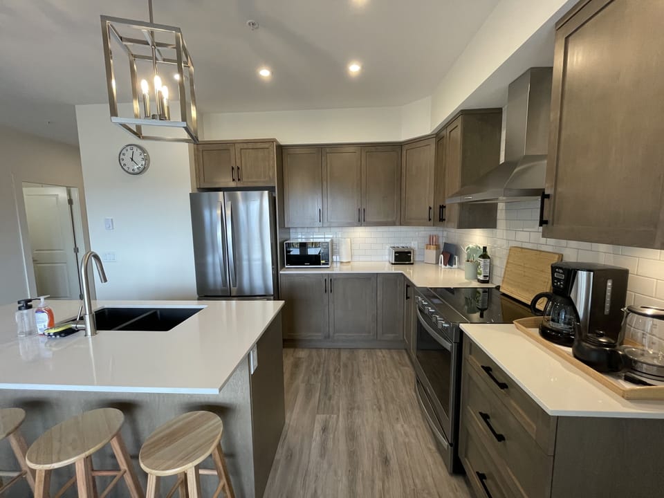 Beautiful kitchen with Quartz counters, stainless appliances, bar seating