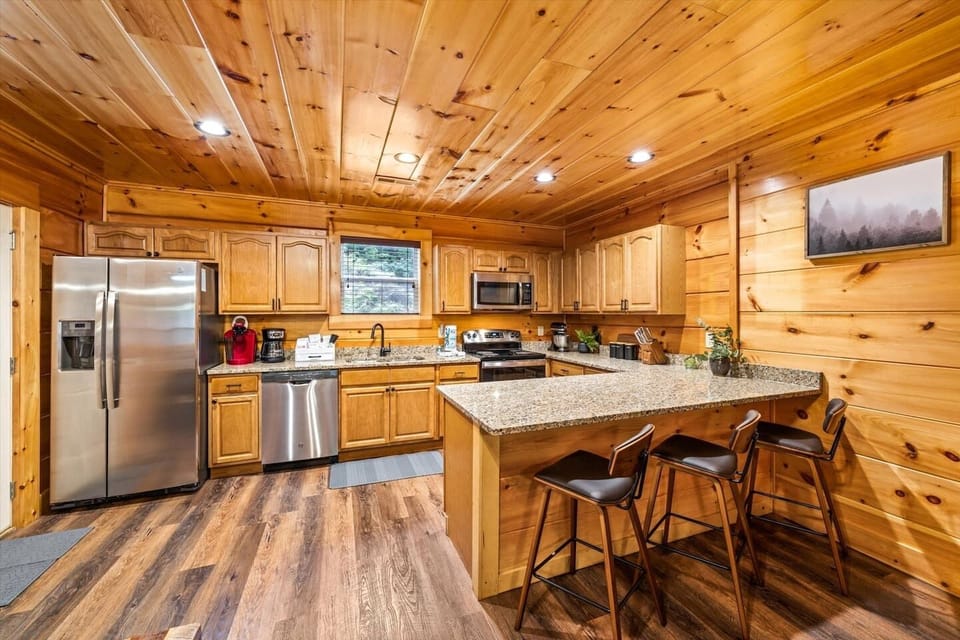 Cabin kitchen with granite and stainless appliances.