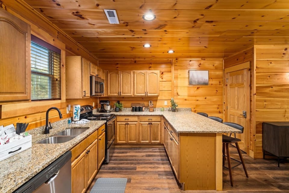 Modern kitchen with granite and stainless steel appliances.