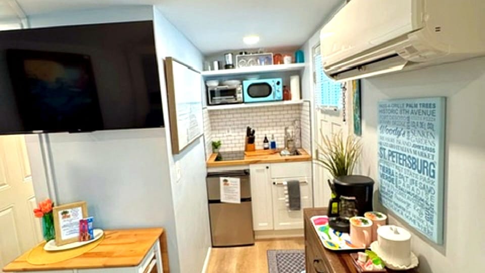 Mini kitchen with fridge and freezer stovetop and sink and toaster oven microwave and coffee