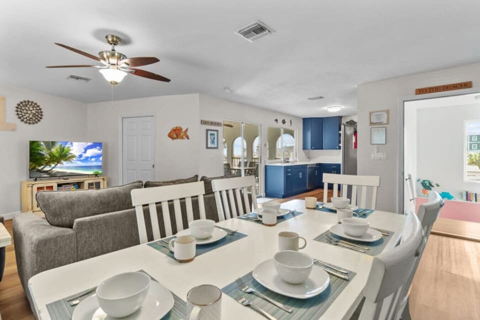 An open-concept layout that flows from the dining table into the living room and kitchen—perfect for staying connected while cooking, lounging, or planning the day ahead.