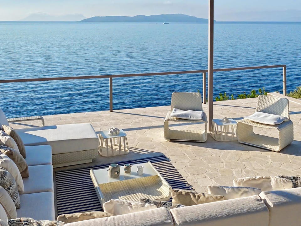 Oceanfront patio seating invites you to relax and soak in the serene views.