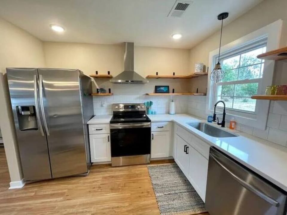 Stocked kitchen with quartz counters and stainless appliances