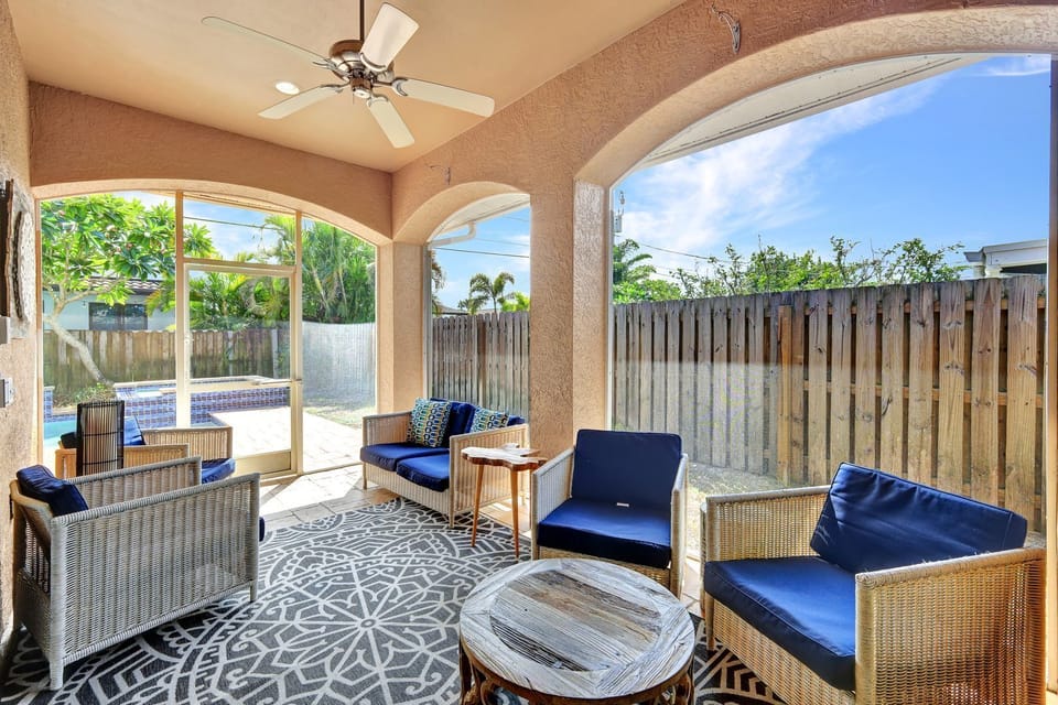 Enclosed Patio | This enclosed patio is the perfect place to relax and enjoy the outdoors. Ceiling fans and chairs keep you cool and comfortable.