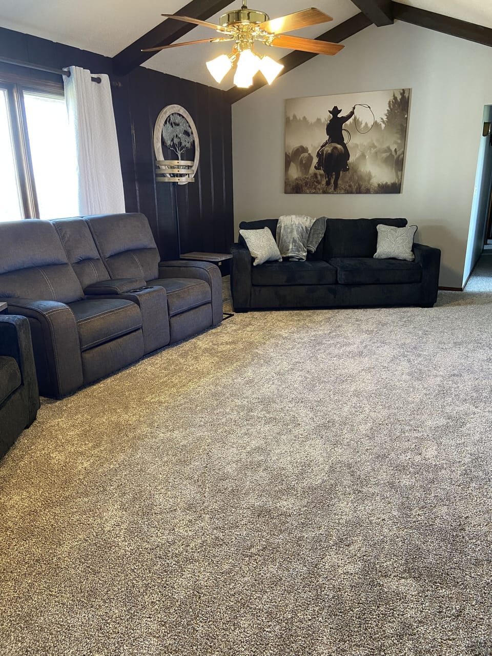 Living room with 2 queen hide a beds and a love seat.