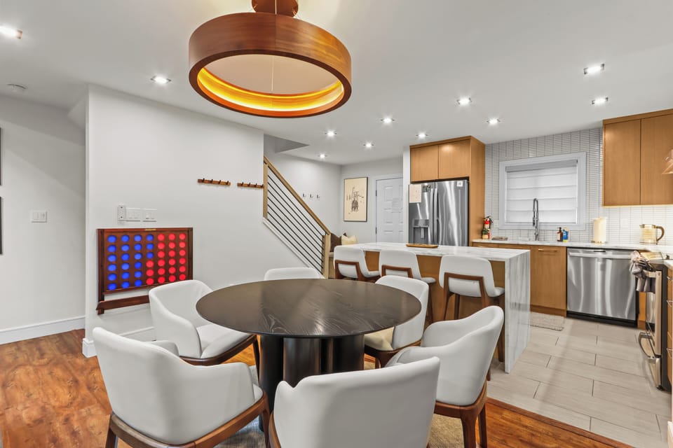 Gather for meals in our open-concept dining area with seating for 8 between the round table and kitchen island! Features a life-size wall game and a baby gate by the stairs. A fully equipped, family-friendly Pocono mountain retreat.