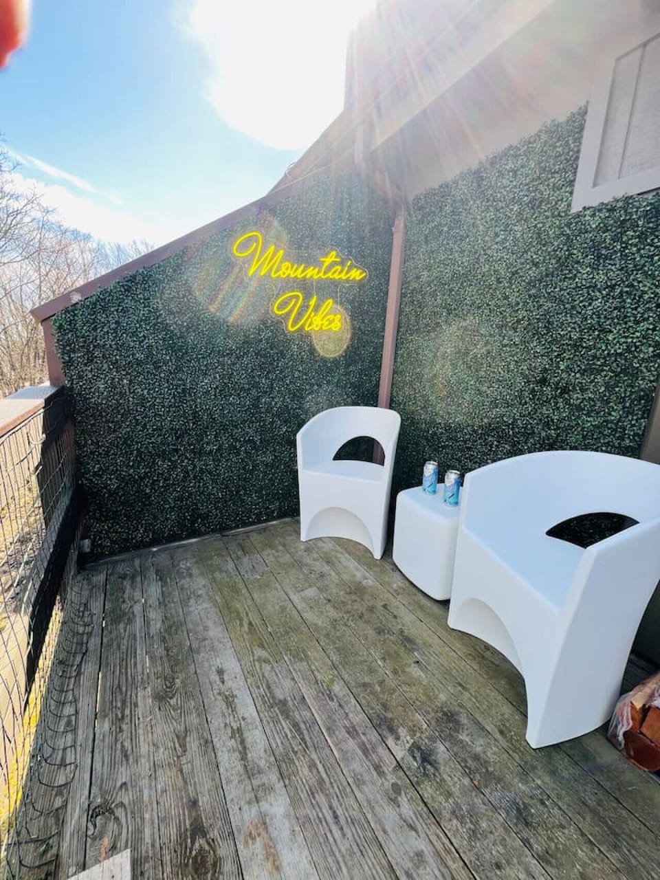 Enjoy our private deck equipped with modern outdoor furniture. Capture the perfect vacation memory in front of our custom "Mountain Vibes" neon sign! An ideal outdoor space to unwind during your dog-friendly Pocono mountain retreat.