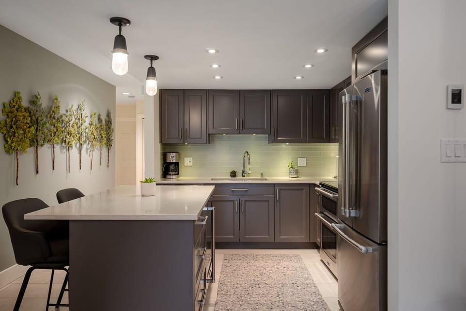 The sleek, fully equipped kitchen features stainless steel appliances and all the essentials for home-cooked meals.