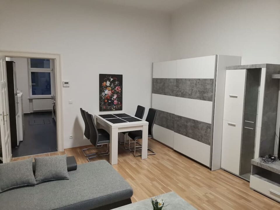 Step into the living room, where Arbio Designers` expertise shines through, creating a warm and inviting atmosphere, perfect for socializing or watching TV.