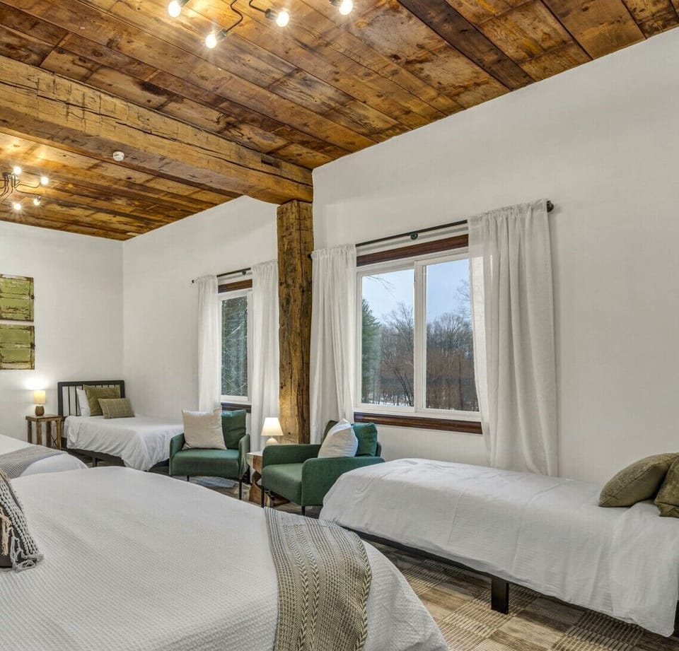 The Barn – Bedroom View
Sunny room with twin beds and big windows that overlook the peaceful pond and trees.