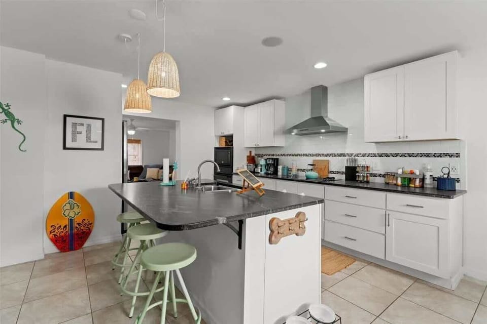 Modern kitchen with a large island and pendant lighting for casual dining.