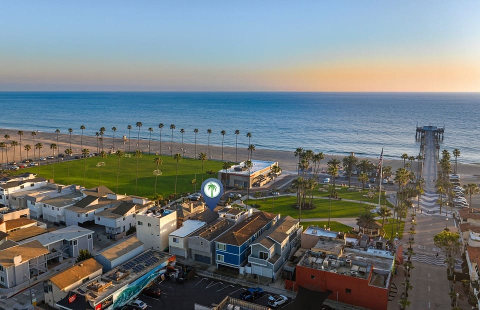 Enjoy an elevated perspective of the home’s unbeatable location—just steps from the beach, lush green park, and iconic pier.
                