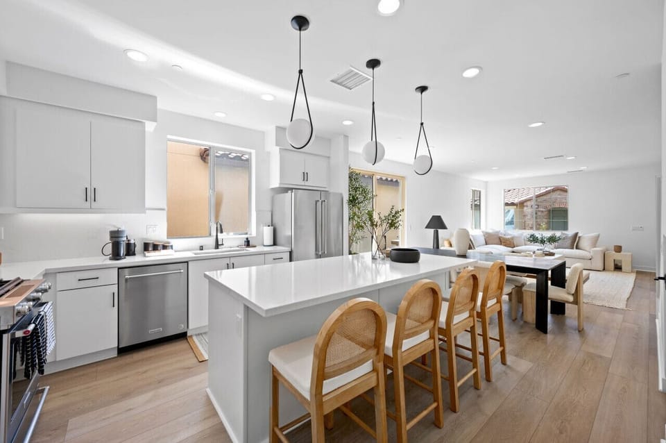 Modern kitchen w/ large island, bar seating & sleek finishes for easy cooking & gathering