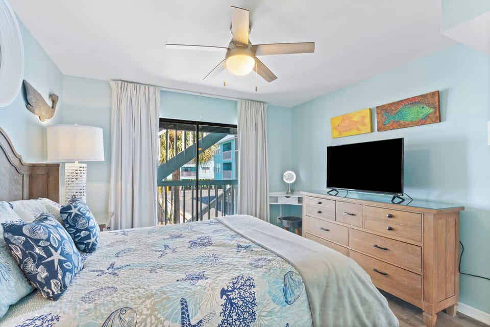 This bedroom has a queen bed as well as a TV