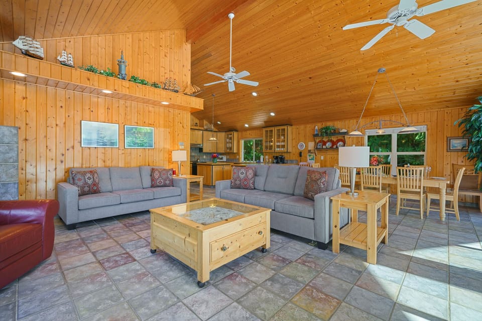 Upstairs open living space with Cable TV, gas fireplace, 2 sleeper sofas, fully stocked kitchen, and dining area. Access to front deck with BBQ.