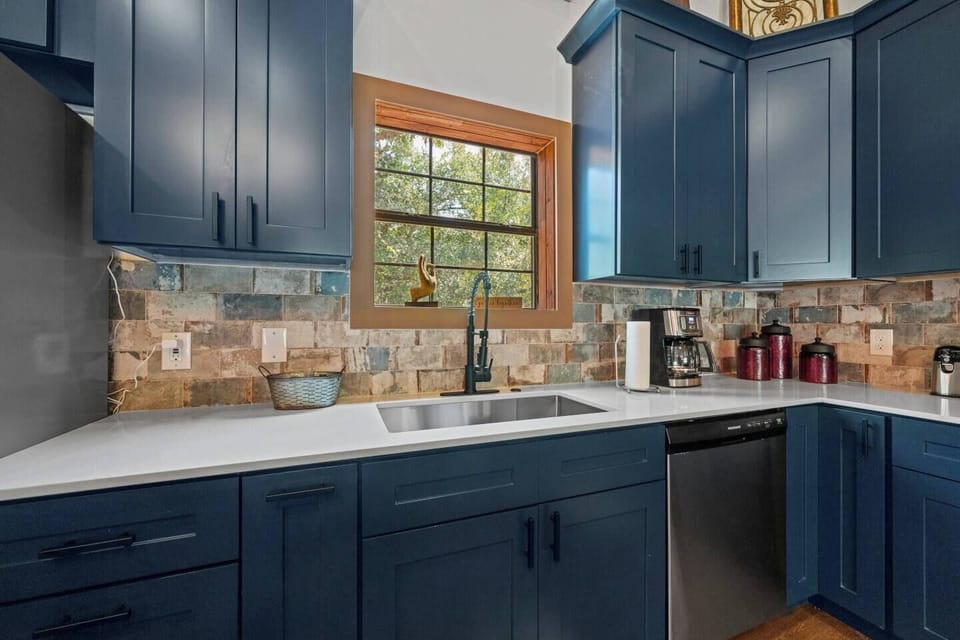 Kitchen: Sleek navy cabinetry meets rustic charm—your culinary adventure starts here!