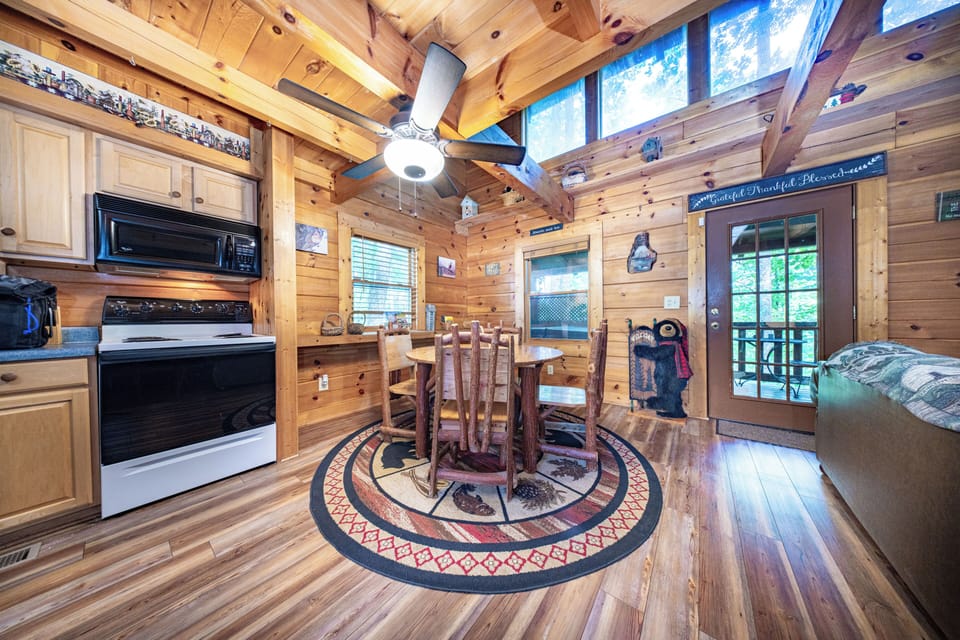 Rustic dining area with wildlife-themed décor and warm wood finishes — perfect for cabin meals.