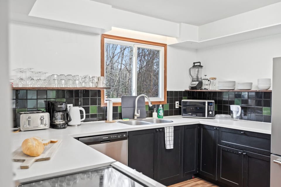 Beautiful, fully equipped kitchen with all major appliances—stove, oven, fridge, dishwasher, and more—plus a lovely view of the backyard!