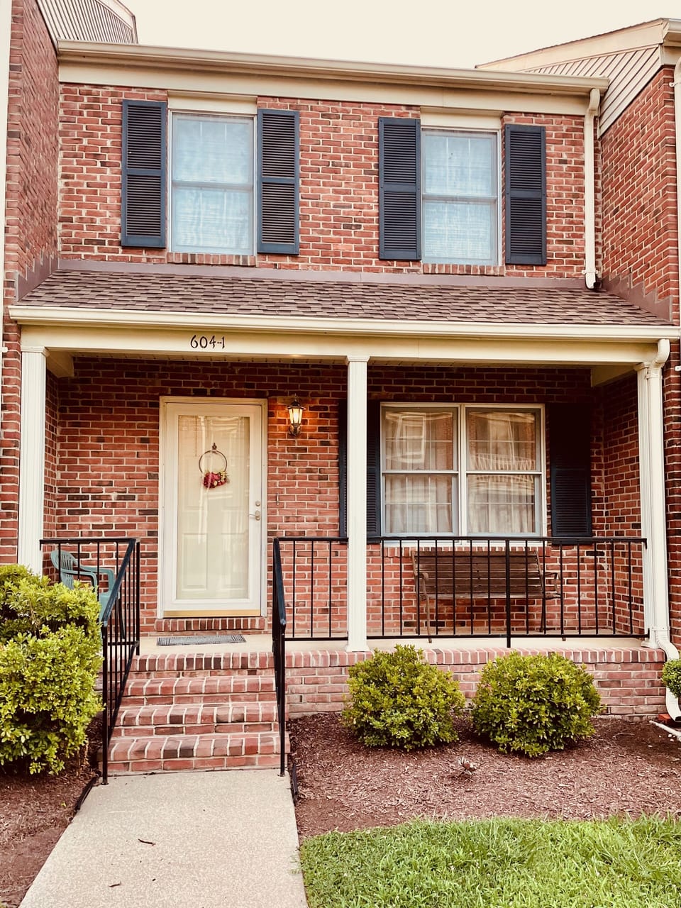 Enjoy a beverage from the cozy front porch with views to the water