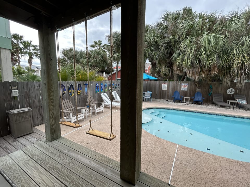 View of Backyard Oasis and your own private heated pool from the patio swings! 