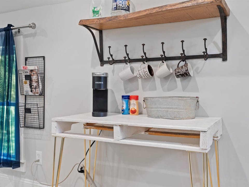 Coffee area stocked with coffee pods & teas with filtered water jugs