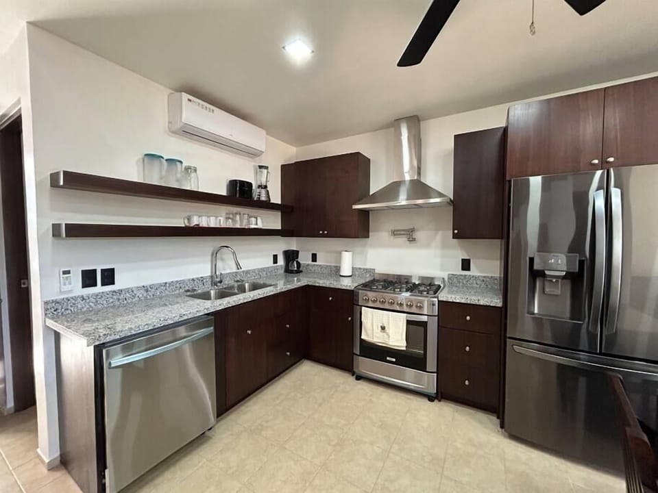 Full kitchen with gas stove, dishwasher, fridge and microwave