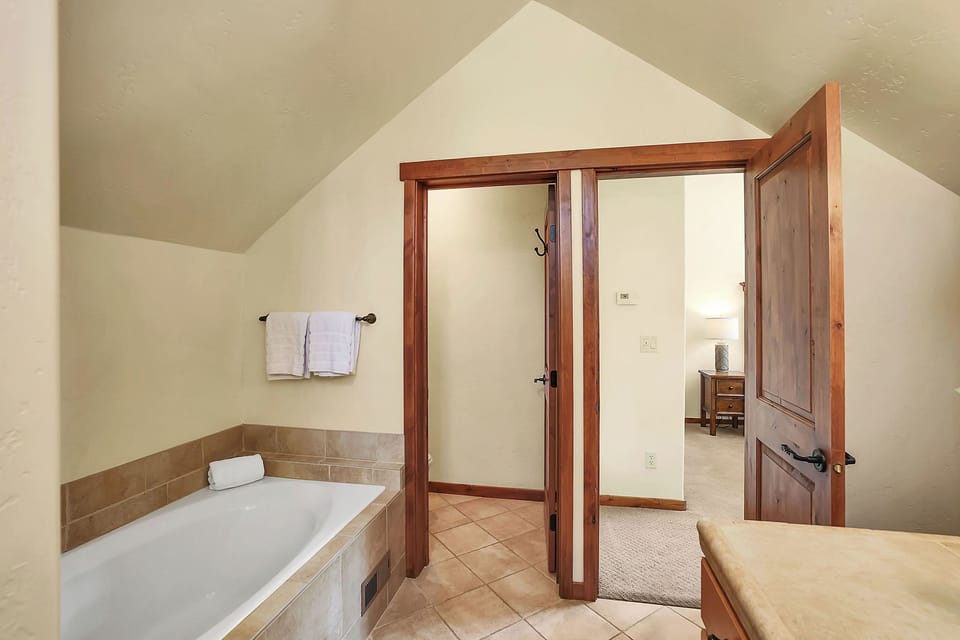 Spa-like Serenity: The ensuite bathroom is a haven of relaxation, featuring a spacious soaker tub and a luxurious walk-in shower, designed to offer you a spa experience right at home