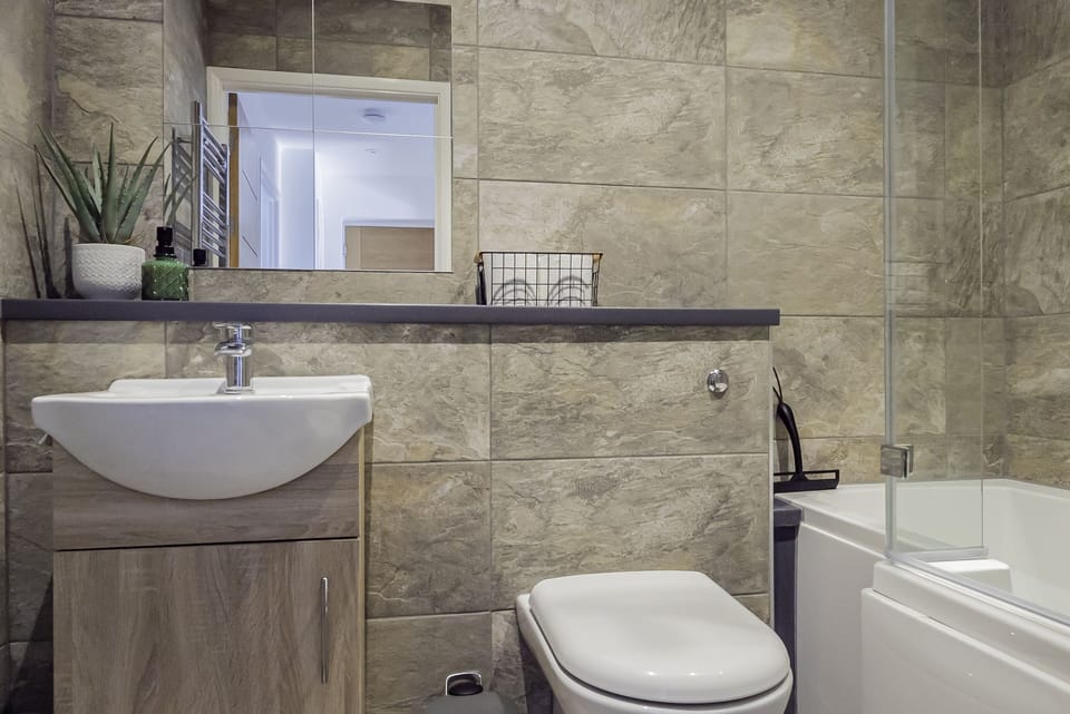 Stylish bathroom with a relaxing bathtub, perfect for unwinding after a long day.