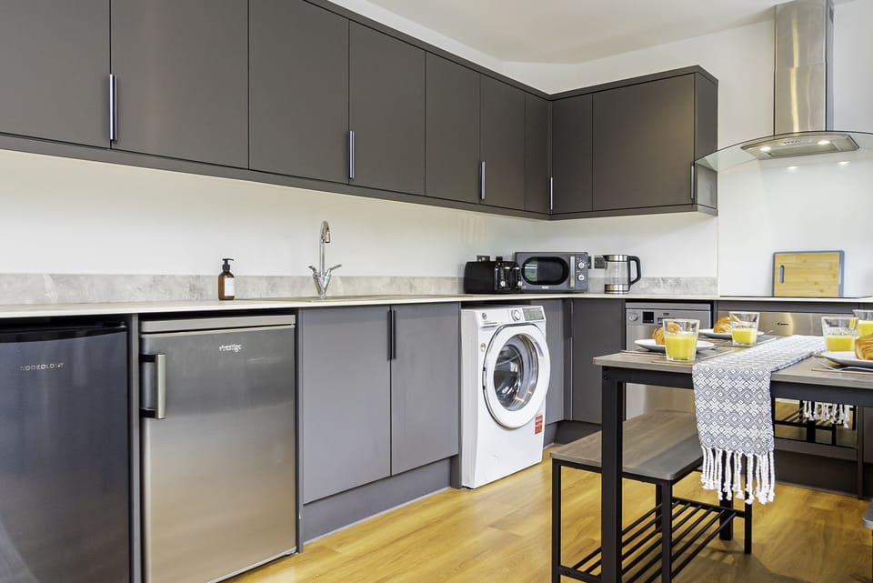 Fully equipped kitchen with sleek, modern appliances, perfect for cooking up your favorite meals during your stay.