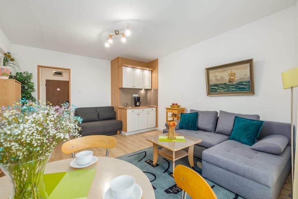 Another angle of the living room showcasing a coffee table with decorative items and a cheerful atmosphere.
