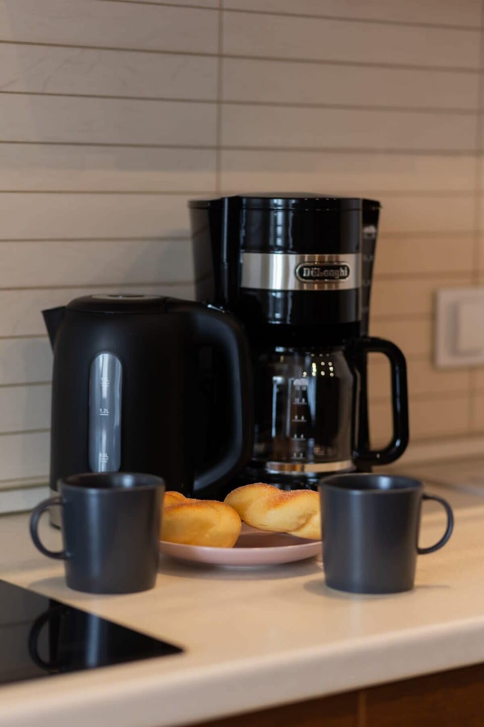 A sleek kitchen counter featuring a modern coffee maker and kettle, perfect for a functional and stylish kitchen space.