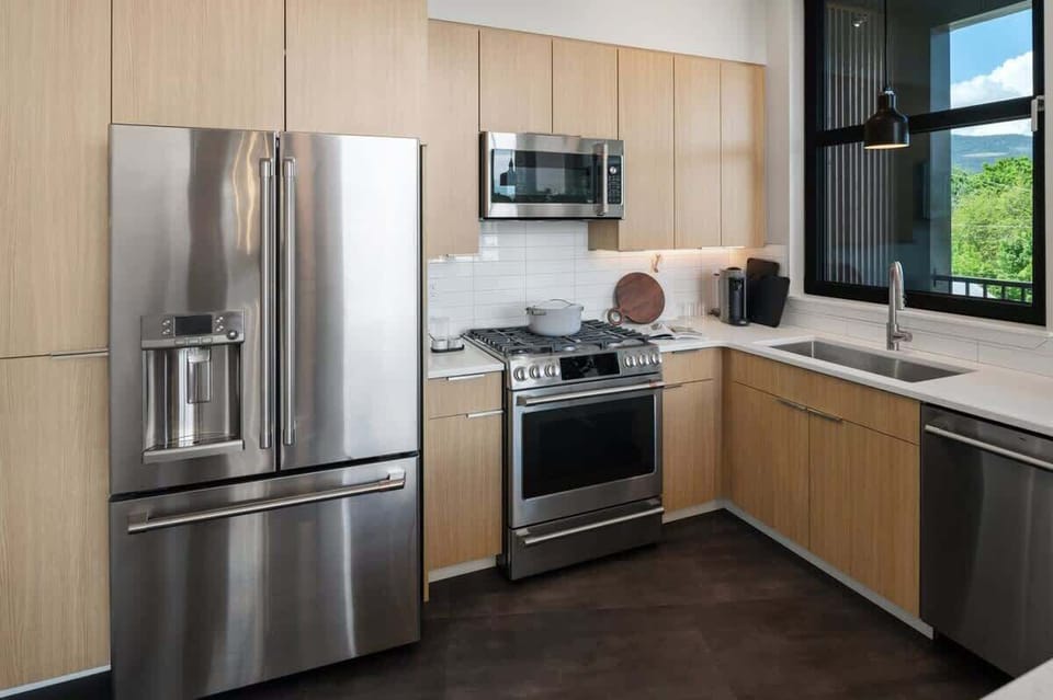 GE Cafe appliances with gas cooktop and electric range. 