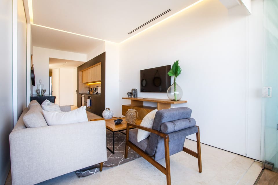 The living room has a custom-made sofa and smart TV