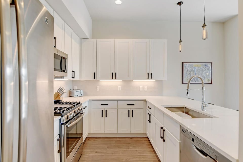 Kitchen with Large Counter Bar Area, Stove, Dishwasher, Refrigerator, and Microwave