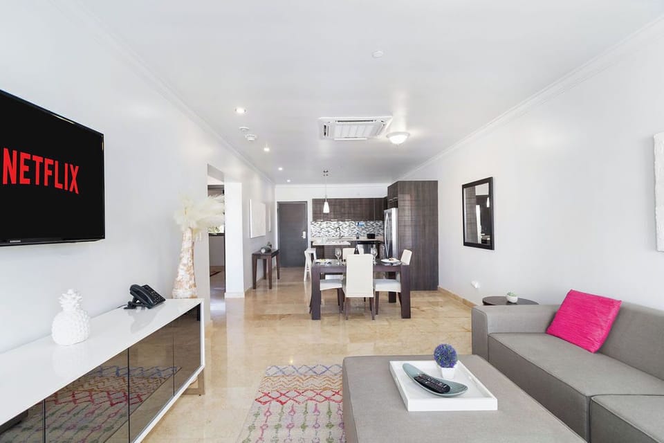 Relax and take in the view in our living room with a TV and balcony access.
