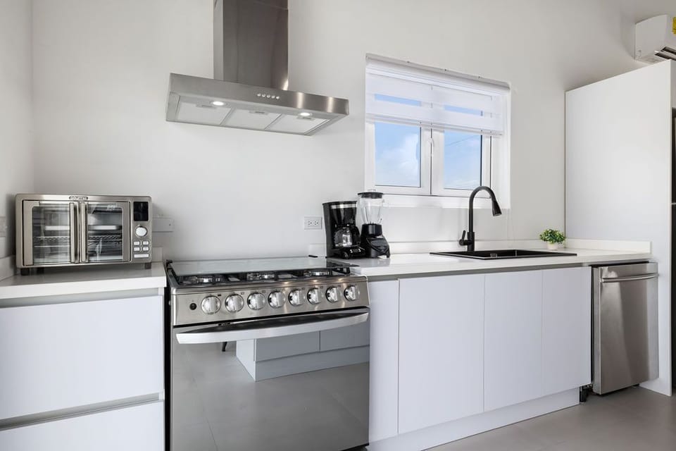 Embrace your inner chef in this gorgeous-modern kitchen with white cabinets and stainless steel appliances.