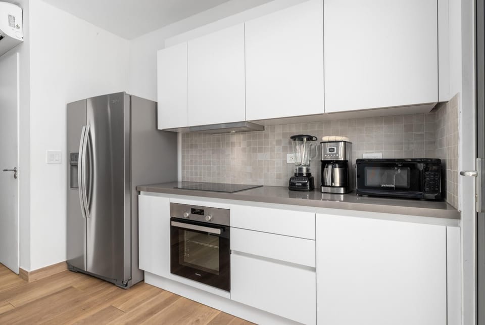 Modern and sleek. Prepare home-cooked meals in this stylish full kitchen and dining